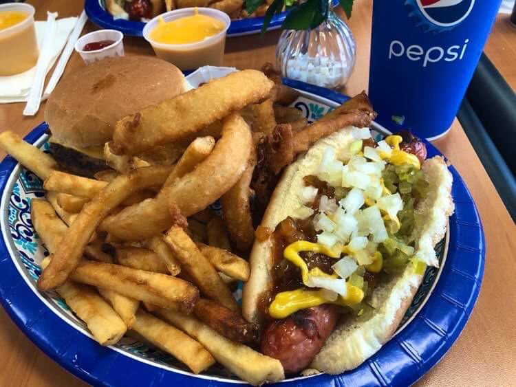 Photo of Jim’s Super Plate: hot dog, burger, onion rings, fries, and Pepsi product