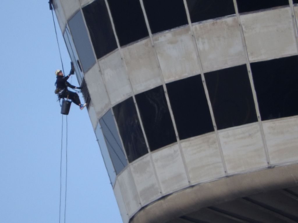 window washer hangs off of Skylon Tower. Niagara Falls, NY
